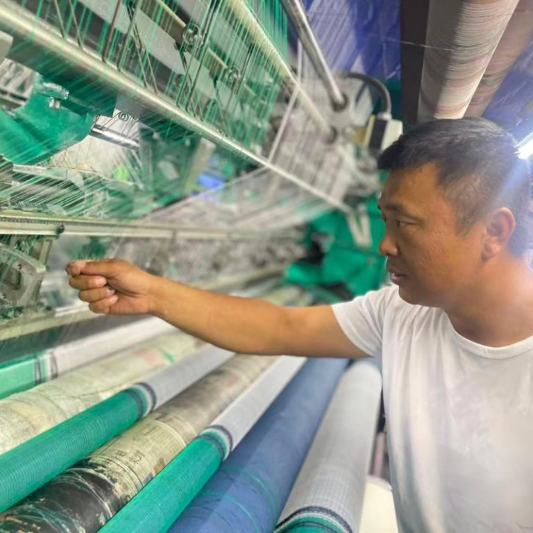 technician inspecting white safety net in UK